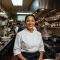 Portrait of Chef Maria Rodriguez smiling in her restaurant kitchen
